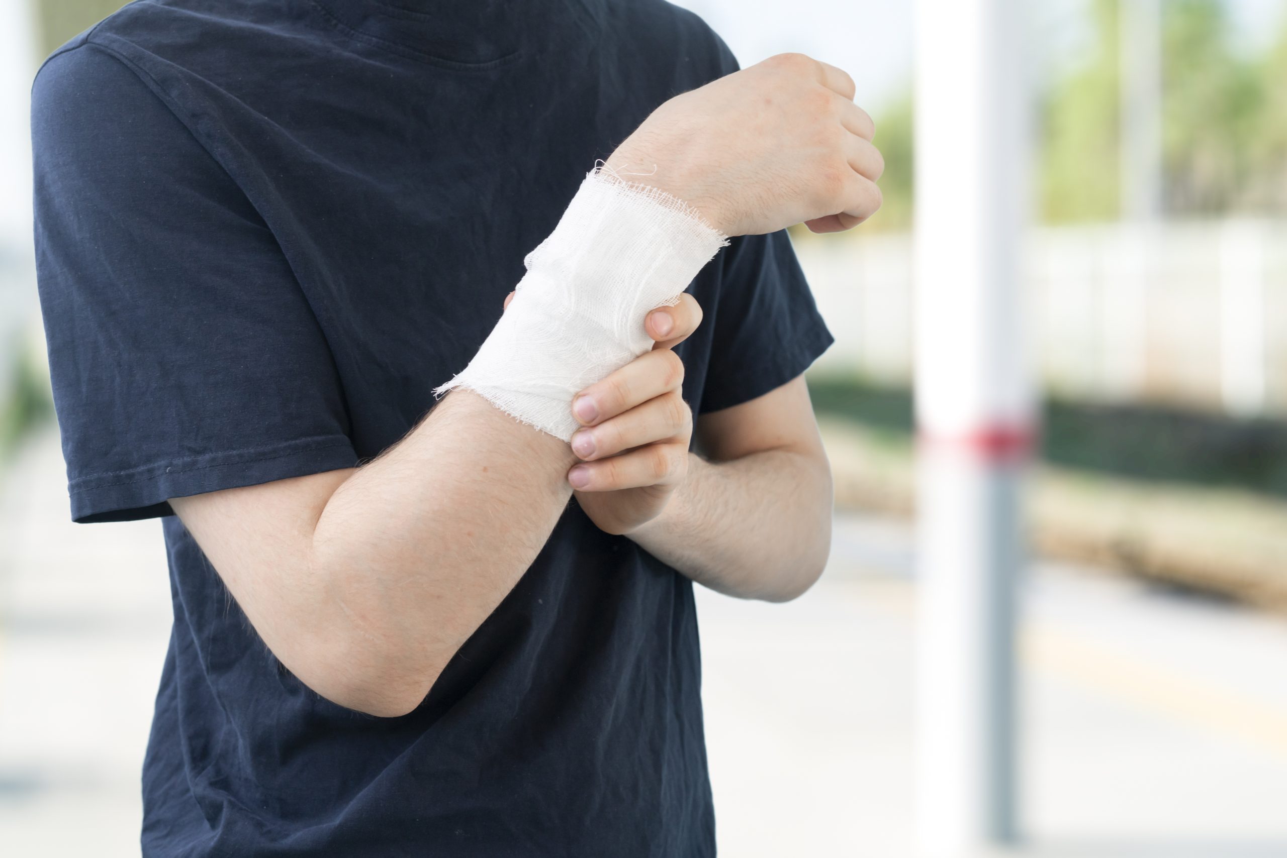 A male person with a white bandage in the arm